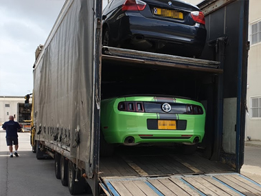 Ford Mustang from UK arrives at our workshop in Spain on covered transporter Ford Mustang on transporter